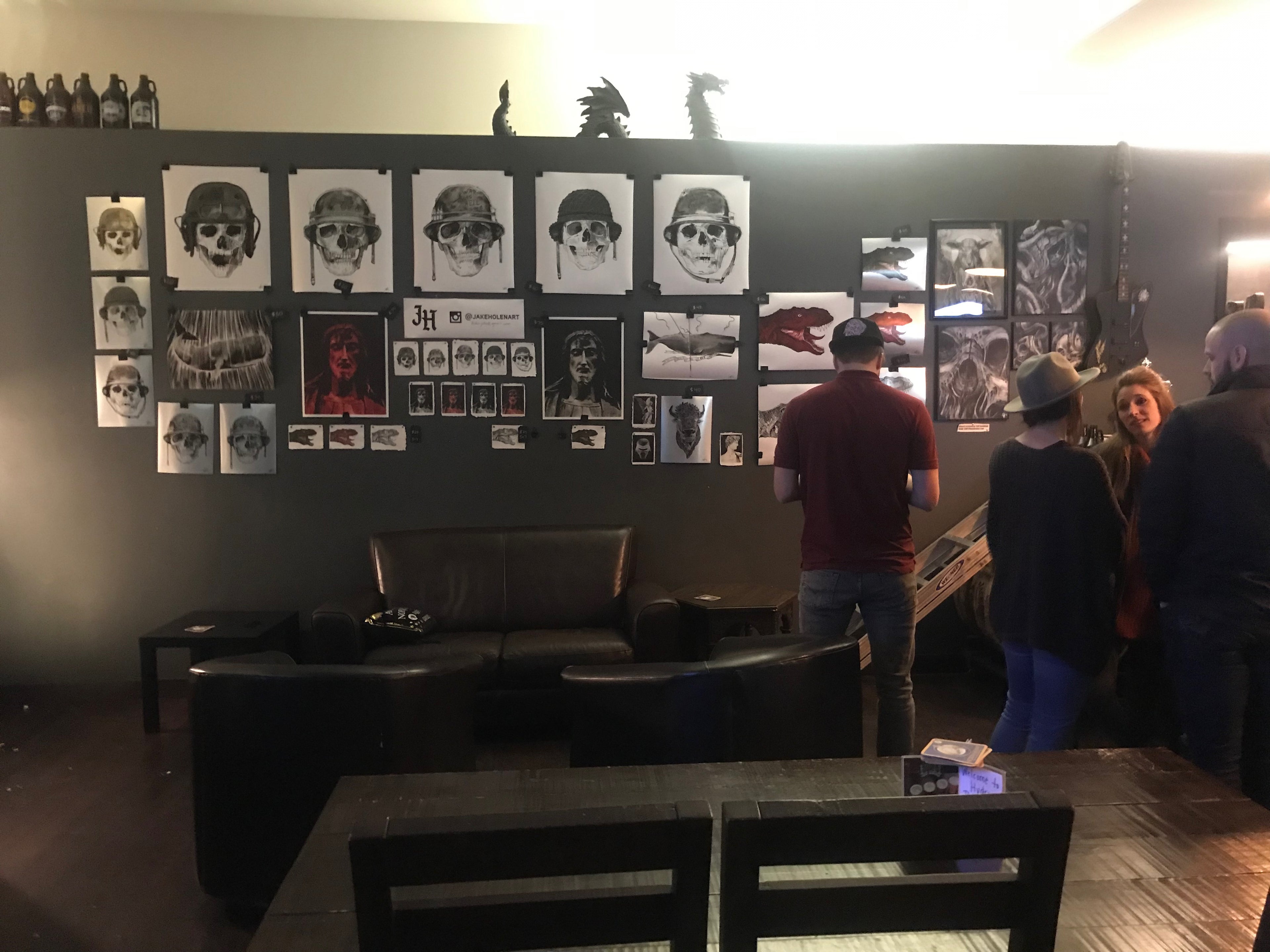 patrons at a brewery looking at artwork for sale