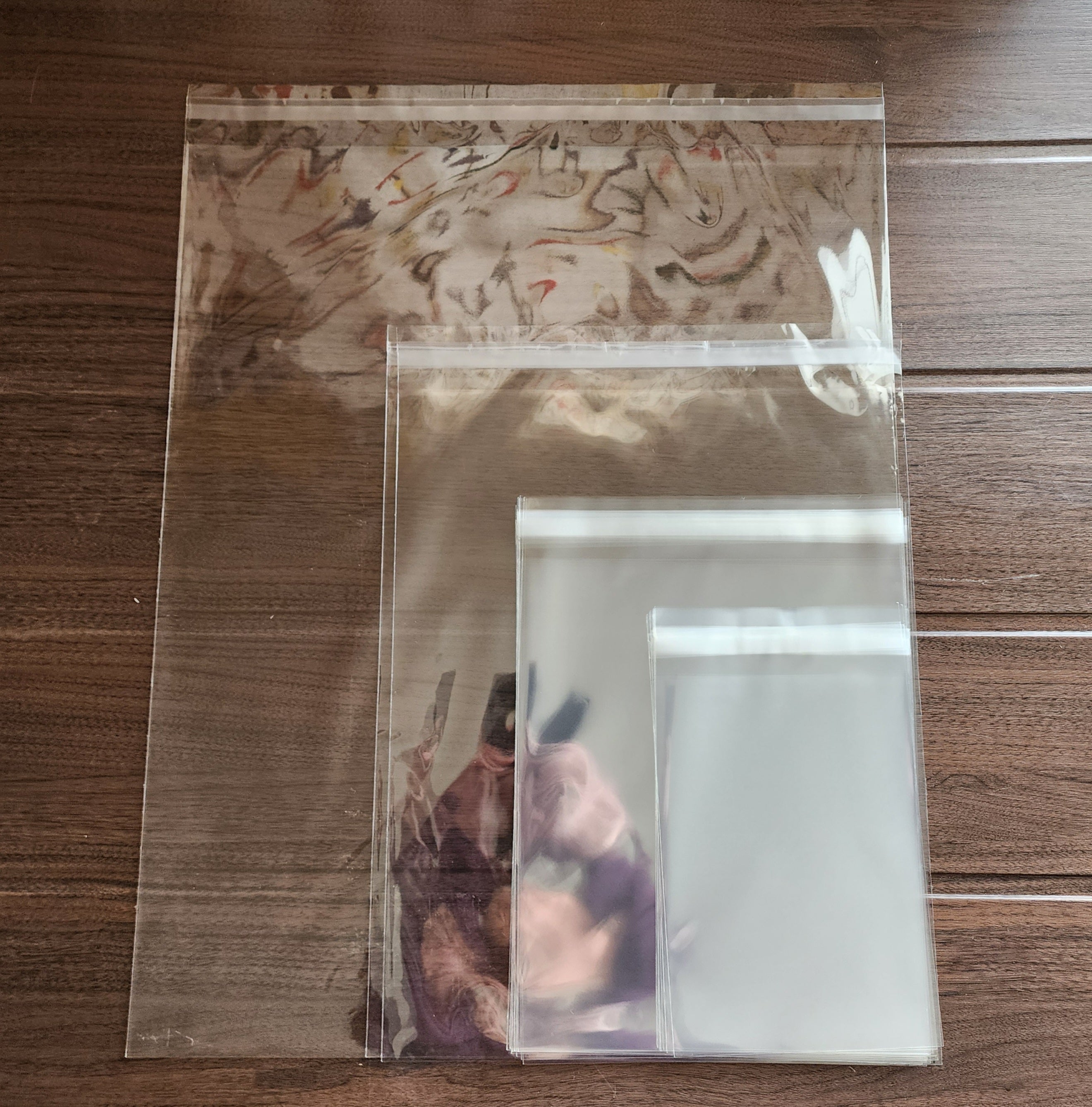 Clear plastic bag with a printed design visible through the plastic. The bag is sealed and placed on a wooden surface.